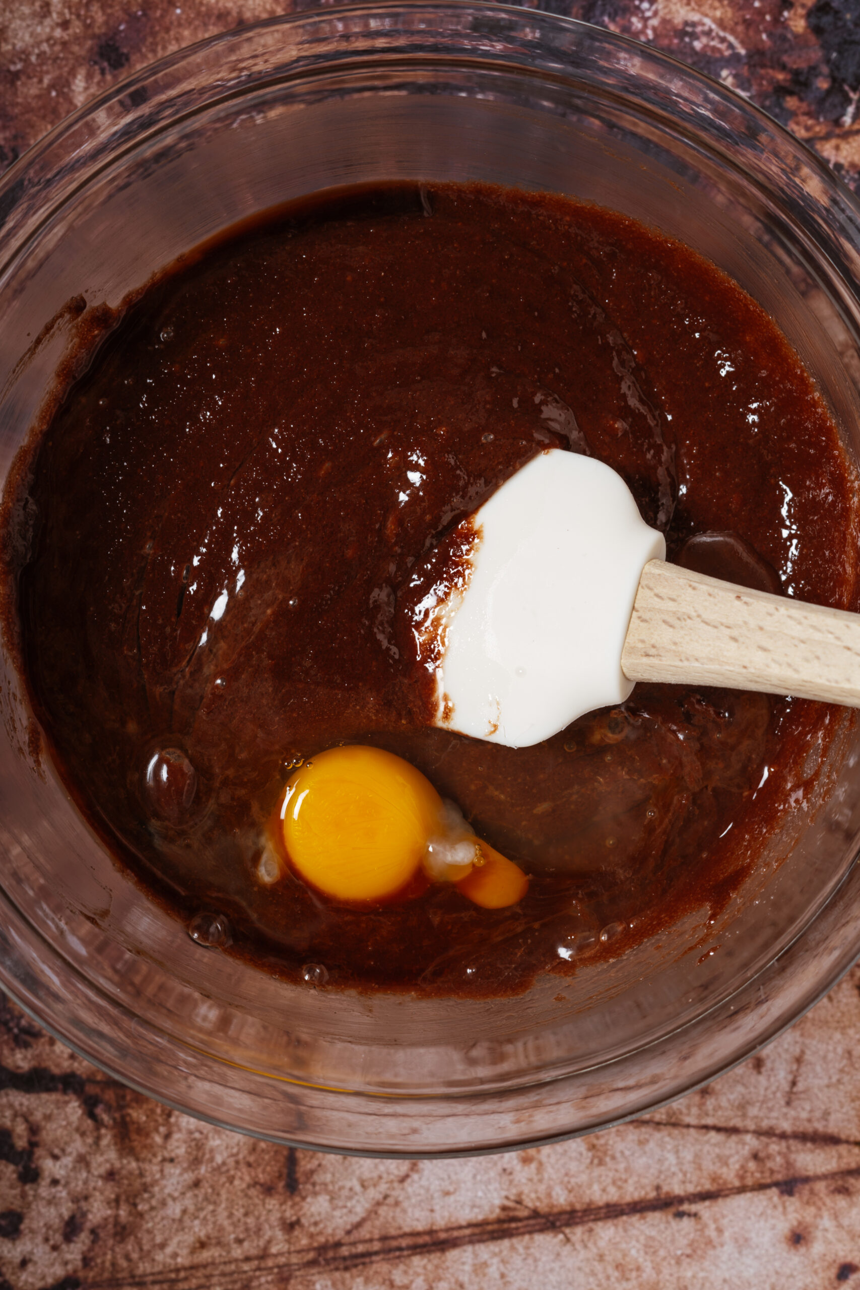 brownie batter and eggs in glass bowl.