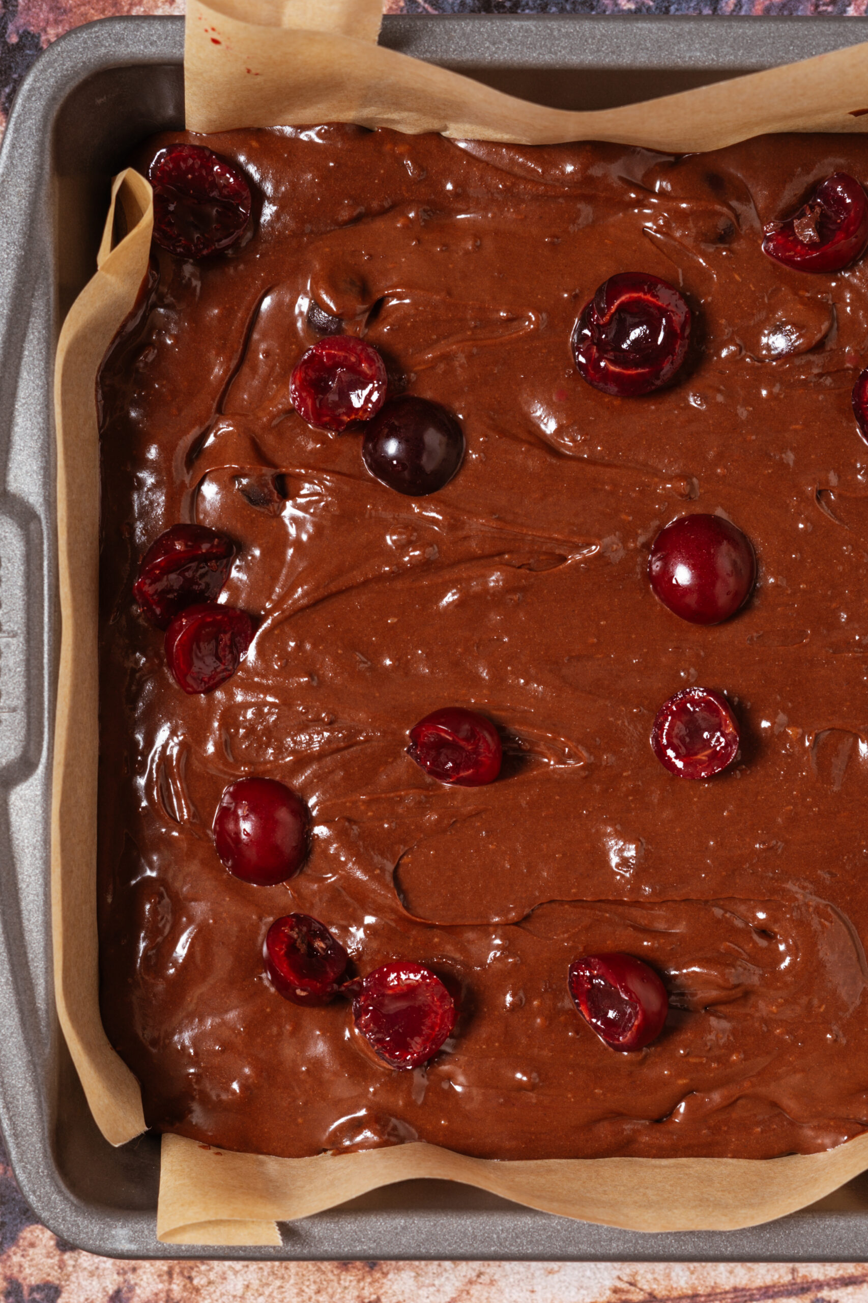 brownie batter in square pan before baking.