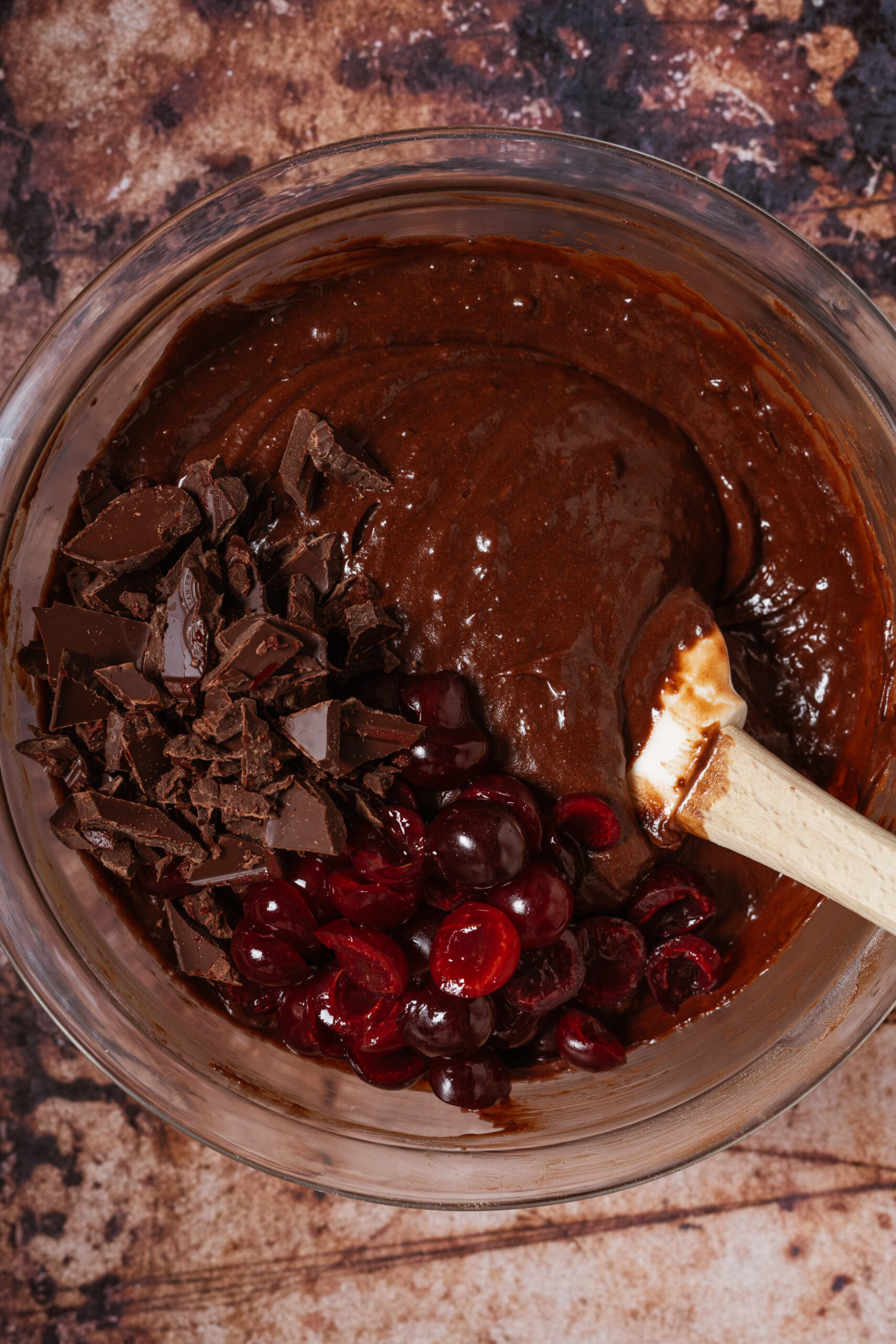 cherries and chocolate in brownie batter bowl before mixing.