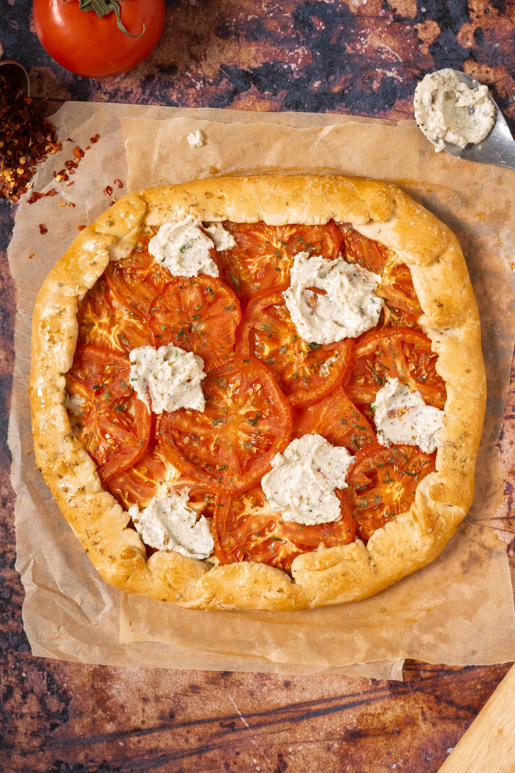 tomato ricotta galette on parchment paper.