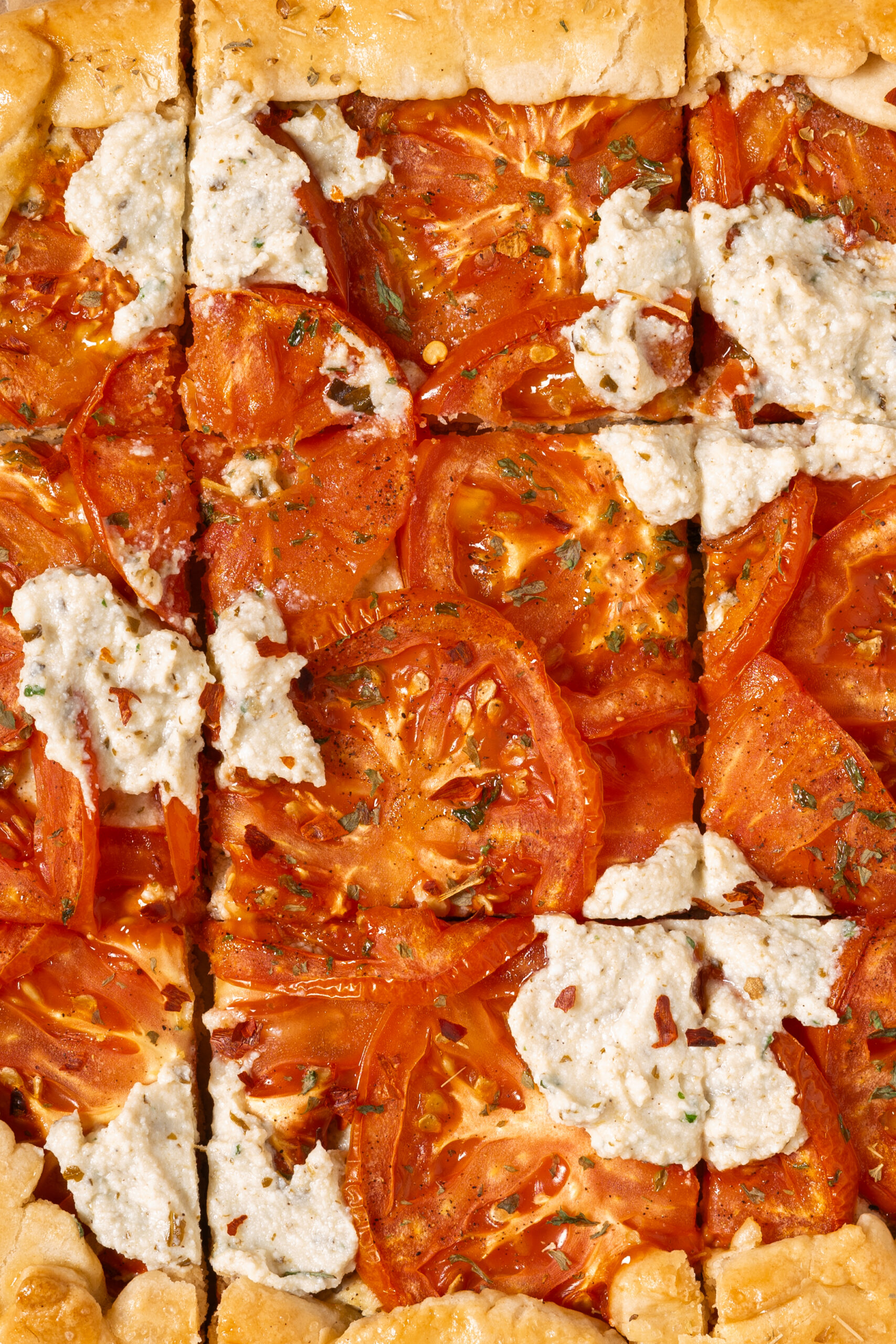 close up of sliced tomato ricotta galette.