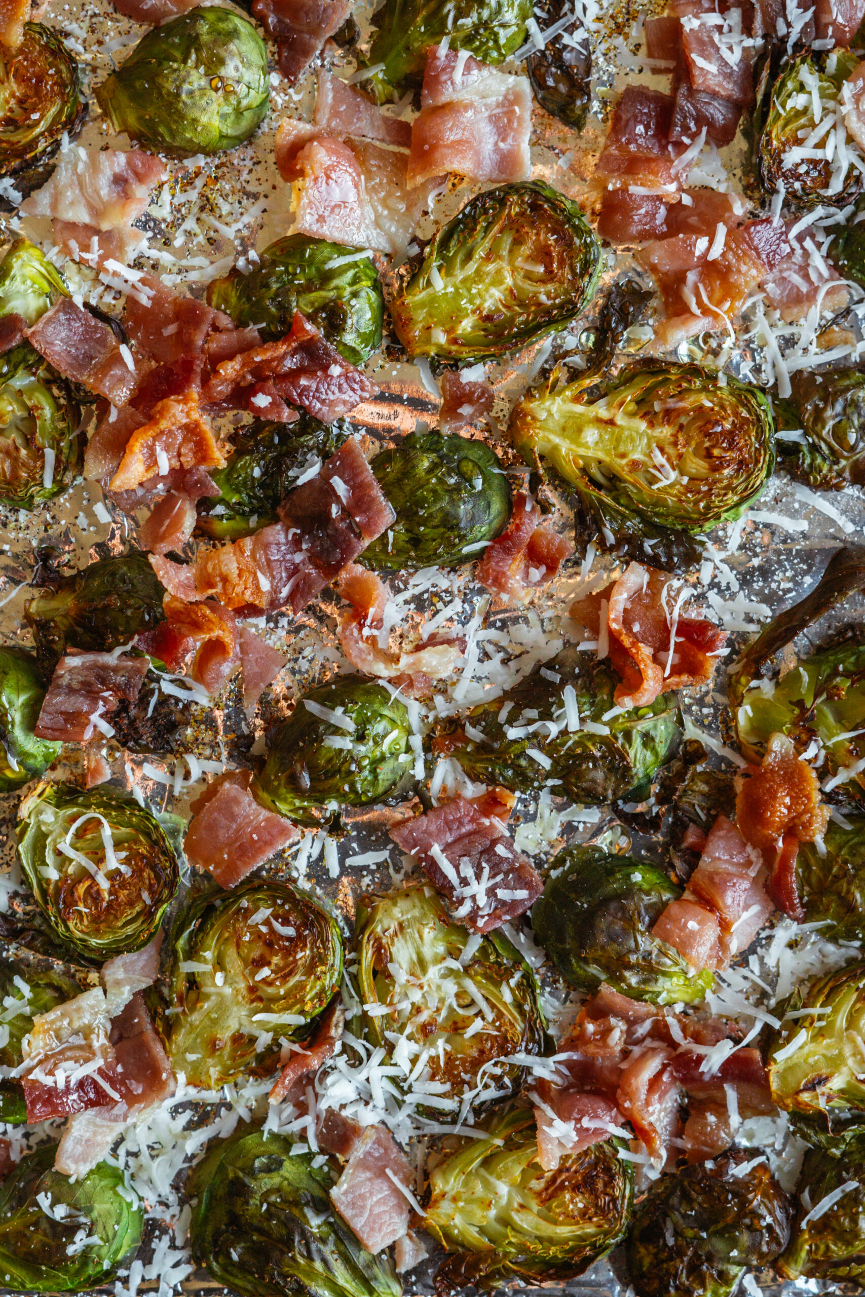 maple bacon brussels sprouts on baking tray with tin foil.