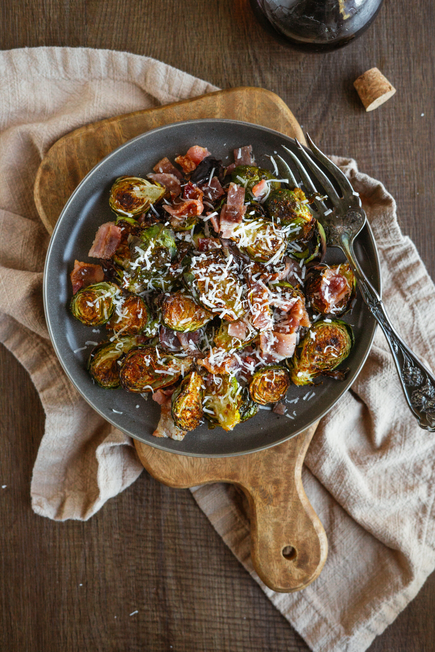 maple bacon brussels sprouts on dark plate with vintage fork.