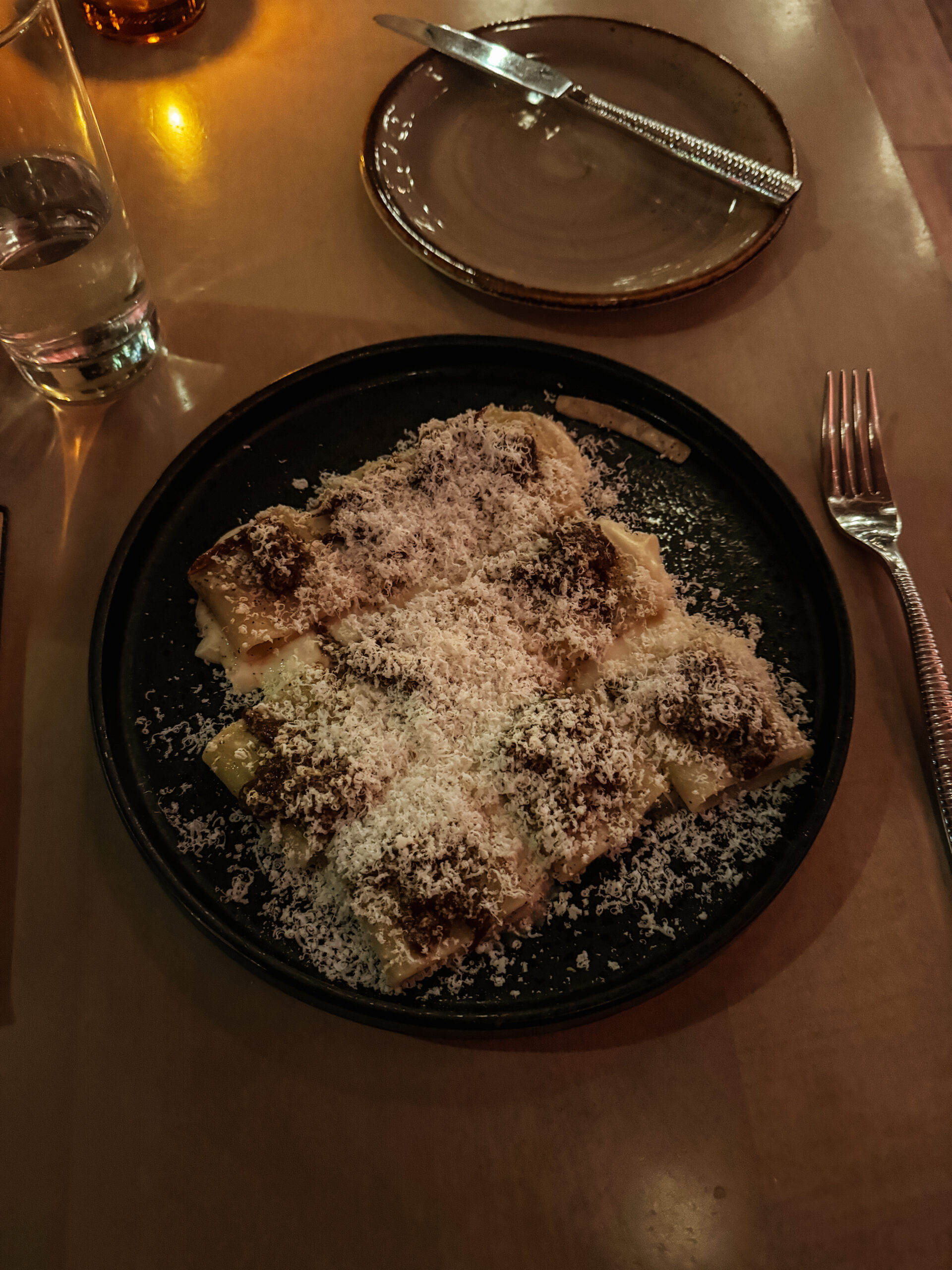 pasta with parmesan cheese on a plate.