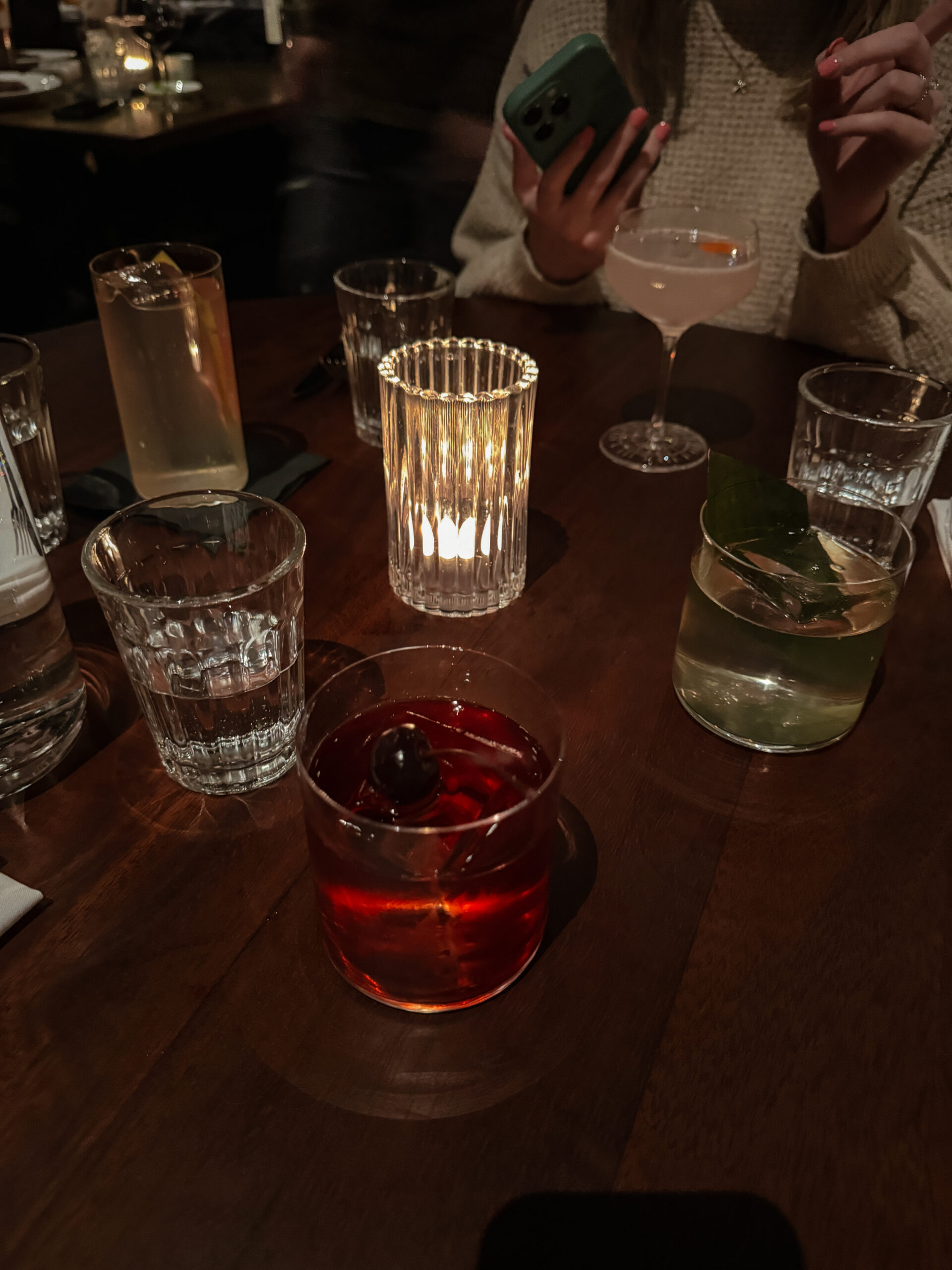 cocktails on table in moody lighting.