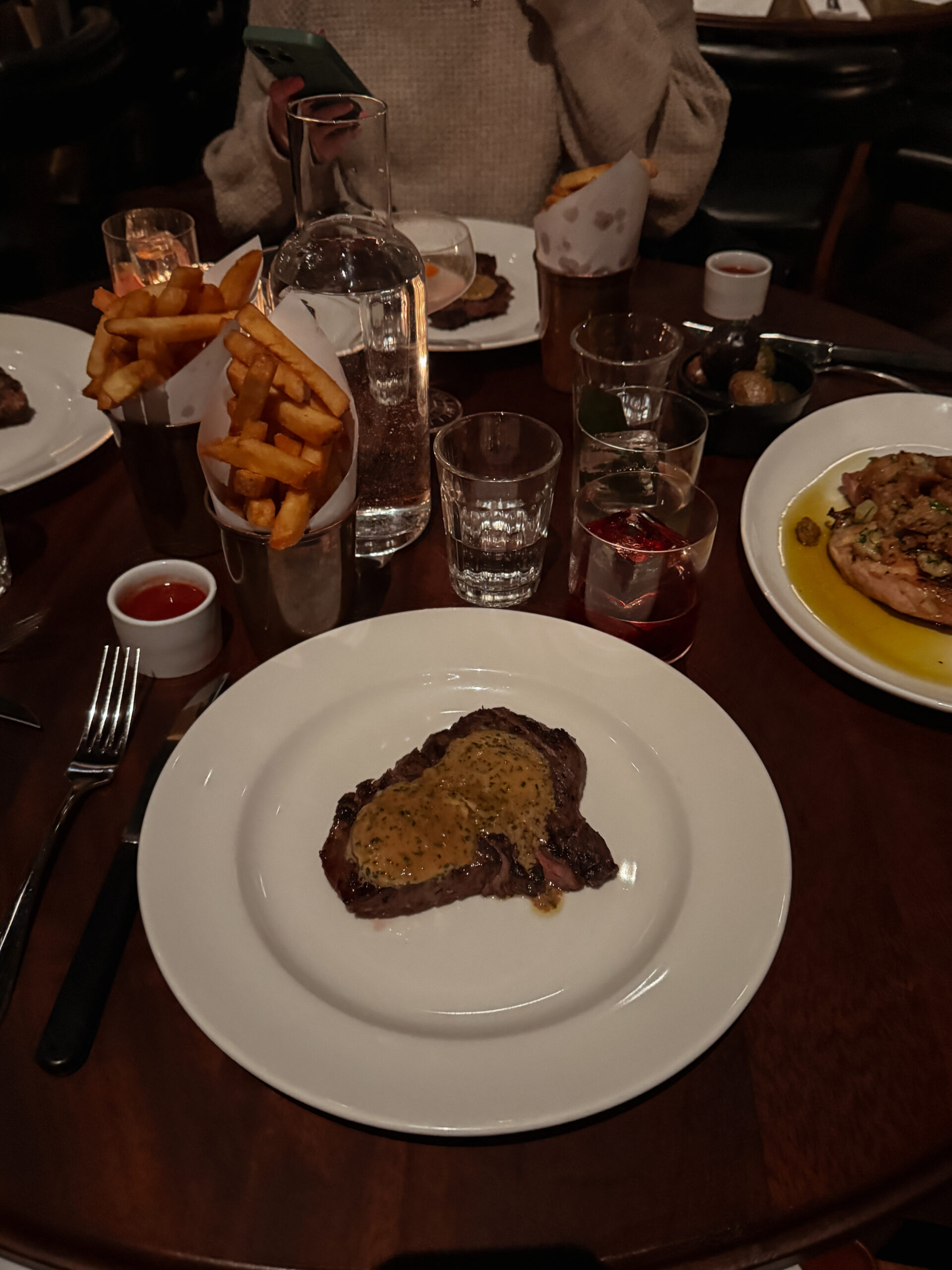 steak and fries on table.