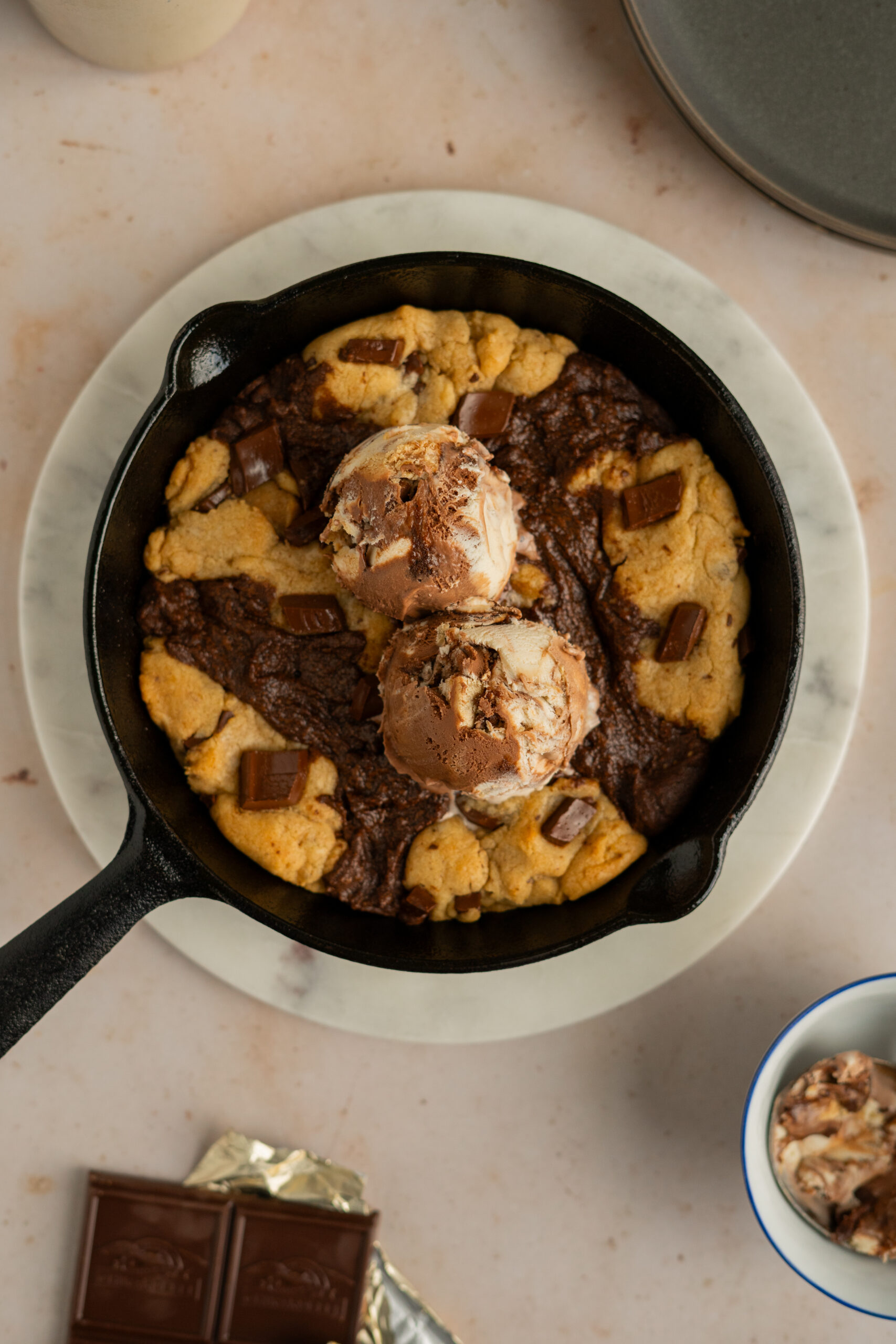 close up of brownie skillet cookie with ice cream on top.