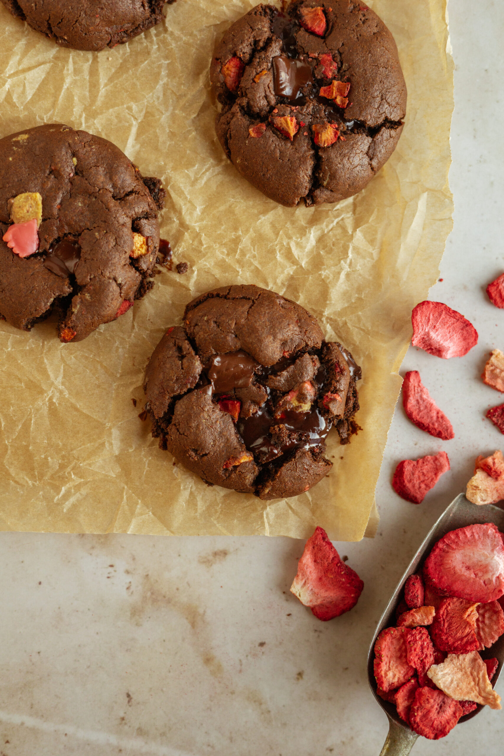 chocolate covered strawberry cookies on parchment paper.