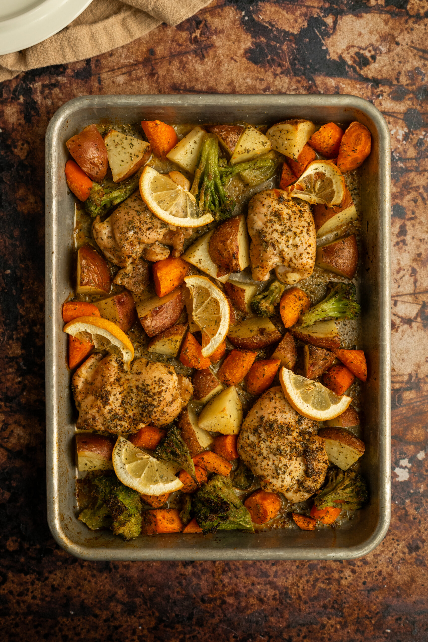 sheet pan of chicken thighs and roasted vegetables.