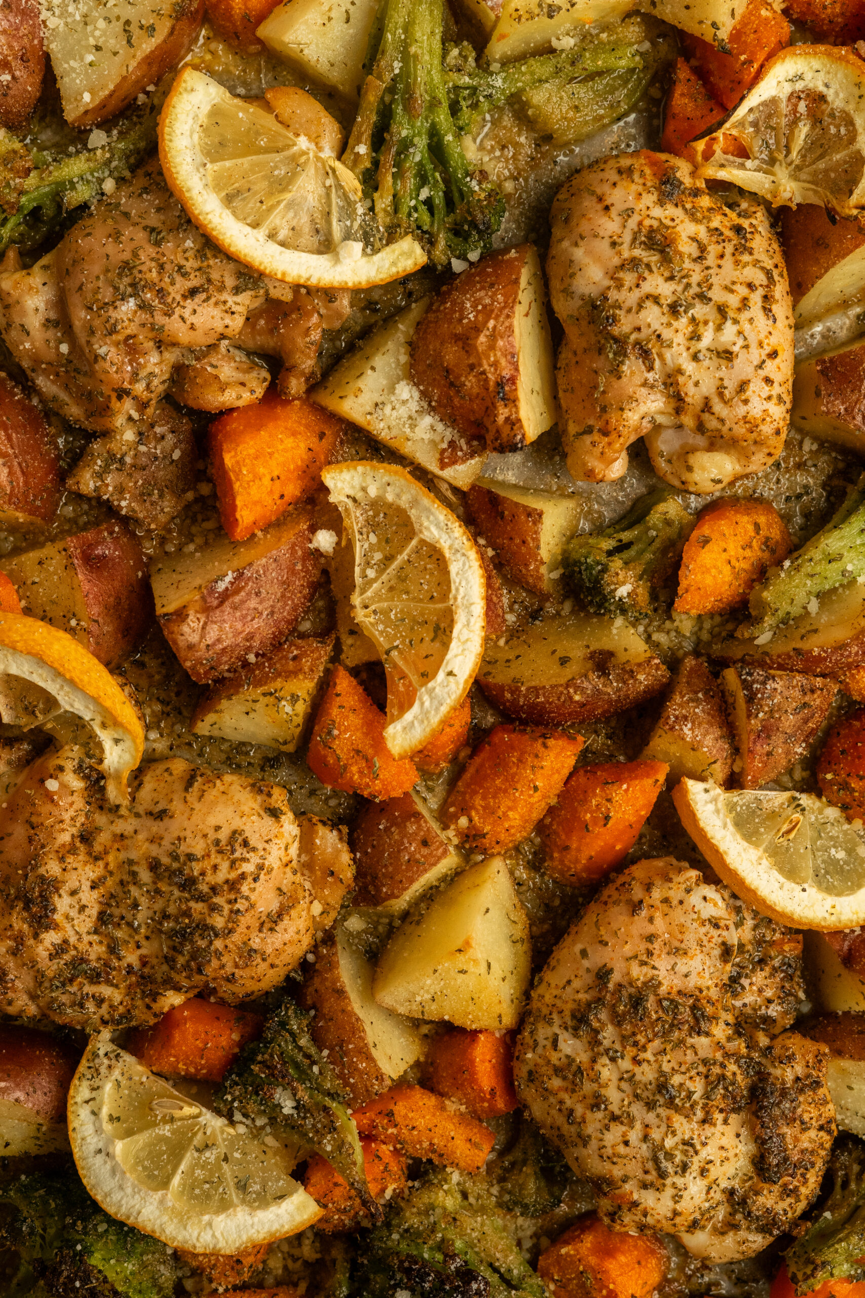 close up of chicken thighs and roasted vegetables.