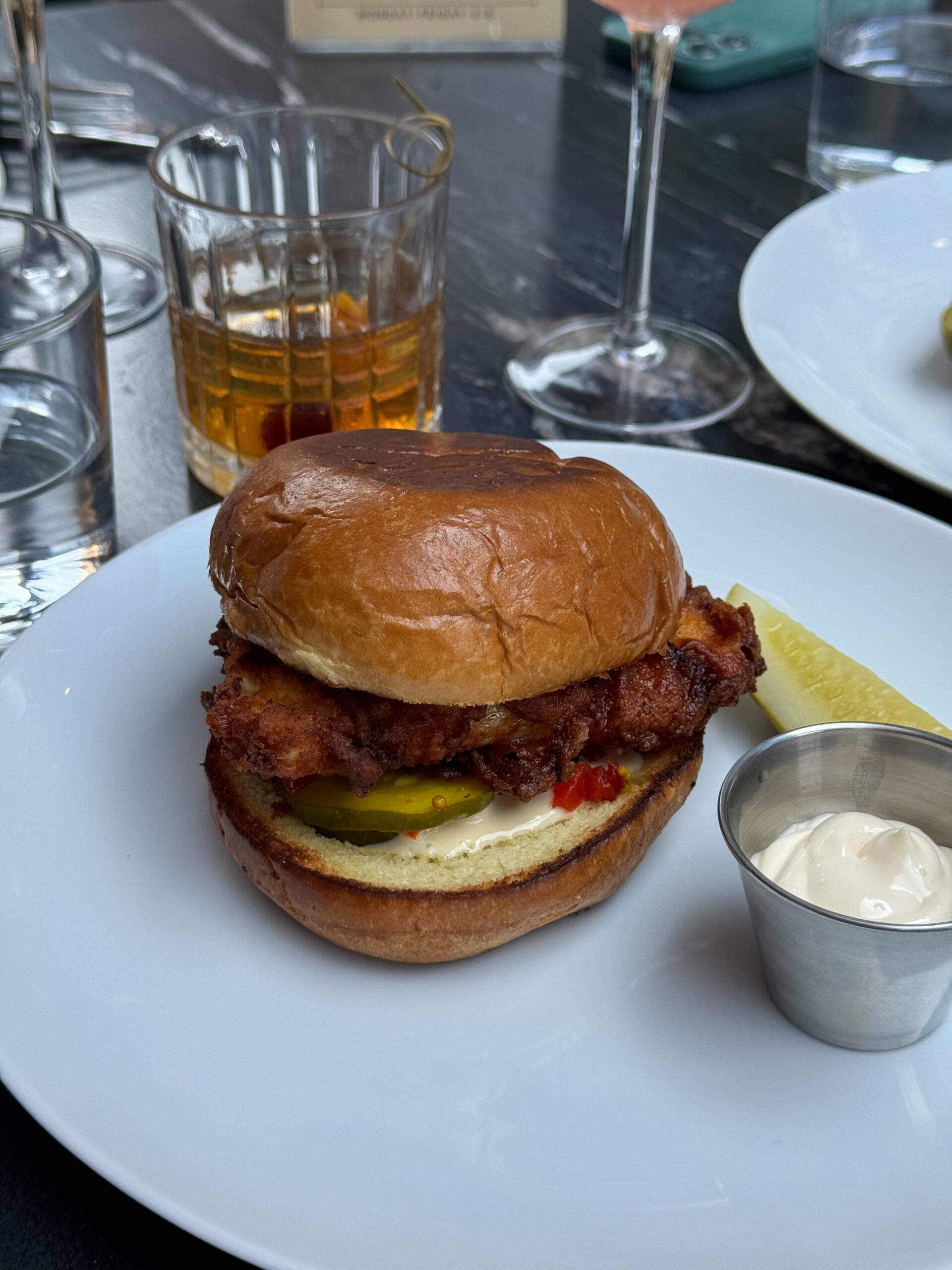 fried chicken sandwich on white plate.