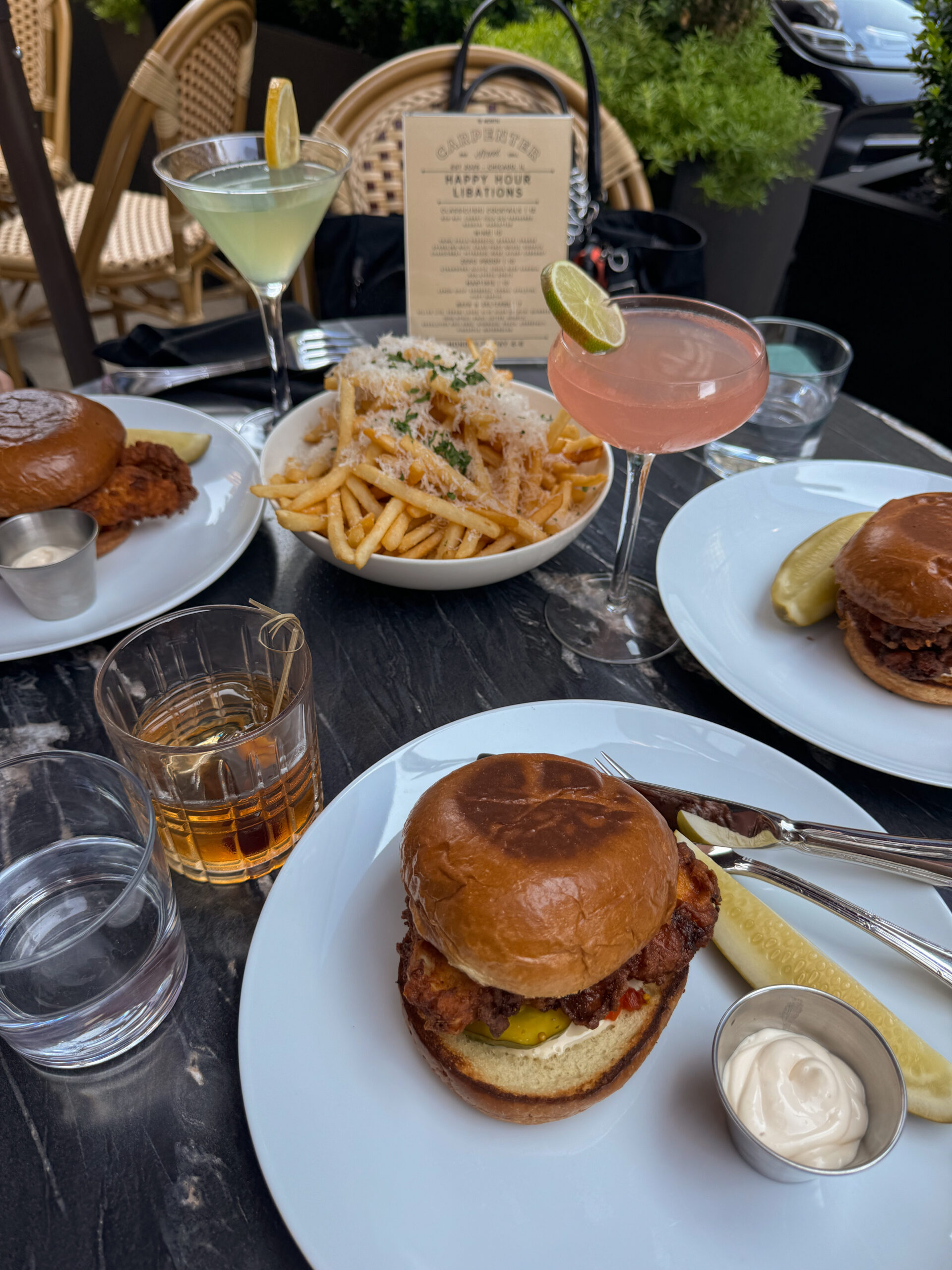 chicken sandwiches and fries on table.