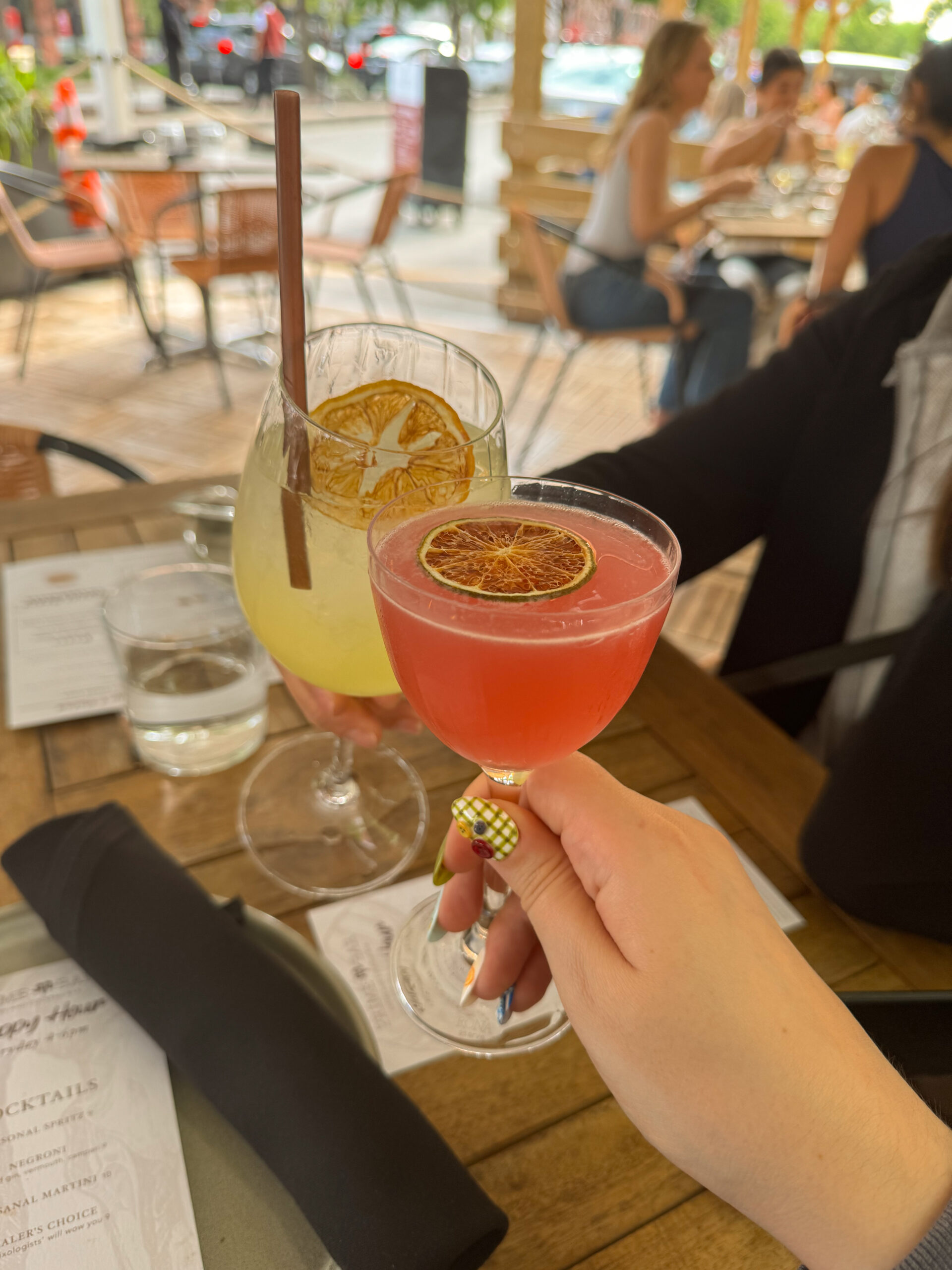 two cocktails clinking together.