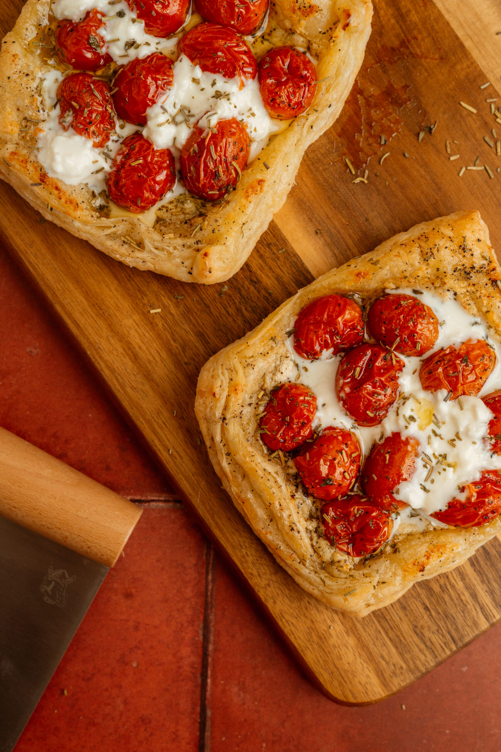 tomato cheese tarts on wooden board.