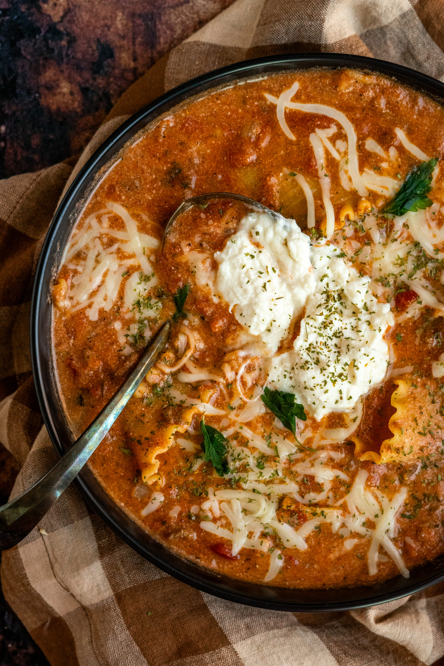 large bowl of lasagna soup with spoon resting in bowl.