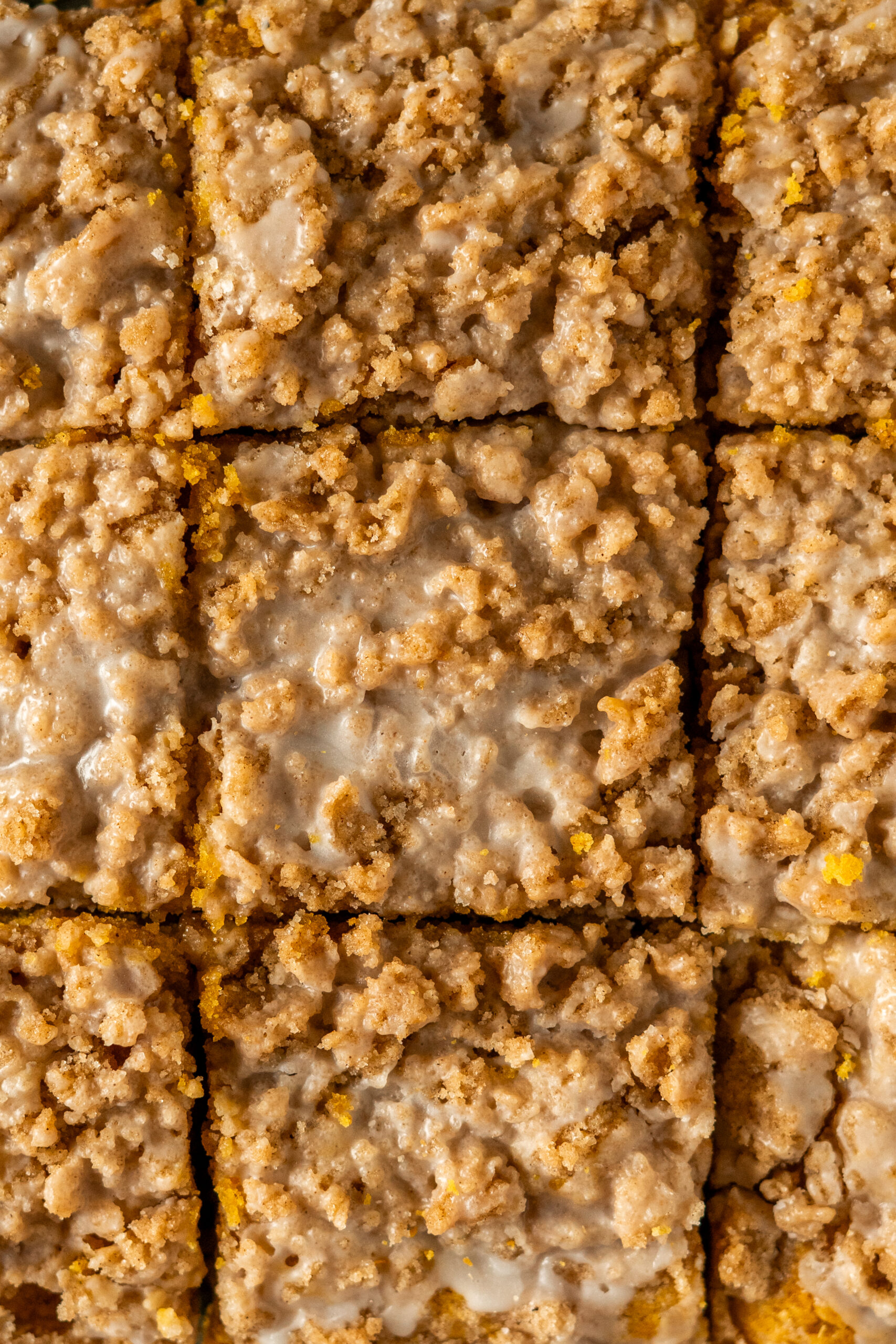 overhead close up view of pumpkin coffee cake sliced into squares.