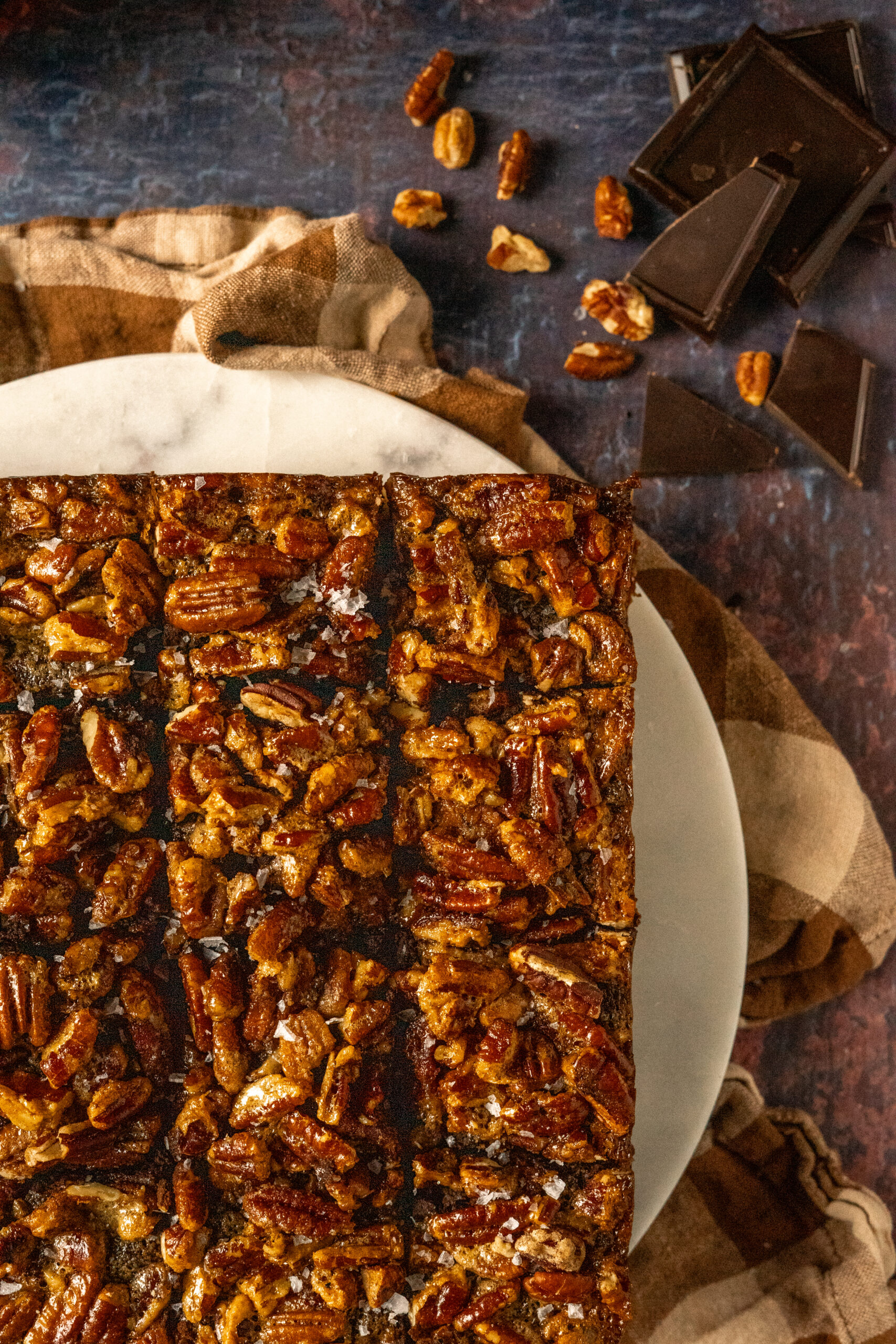 overhead view of pecan pie brownies sliced on a marble slab.