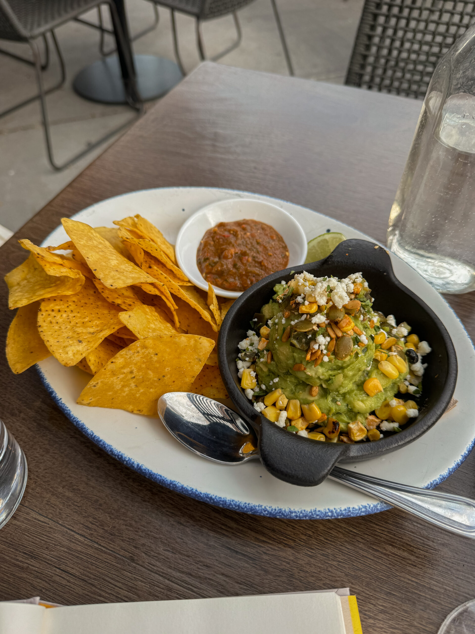 guacamole and chips on table.
