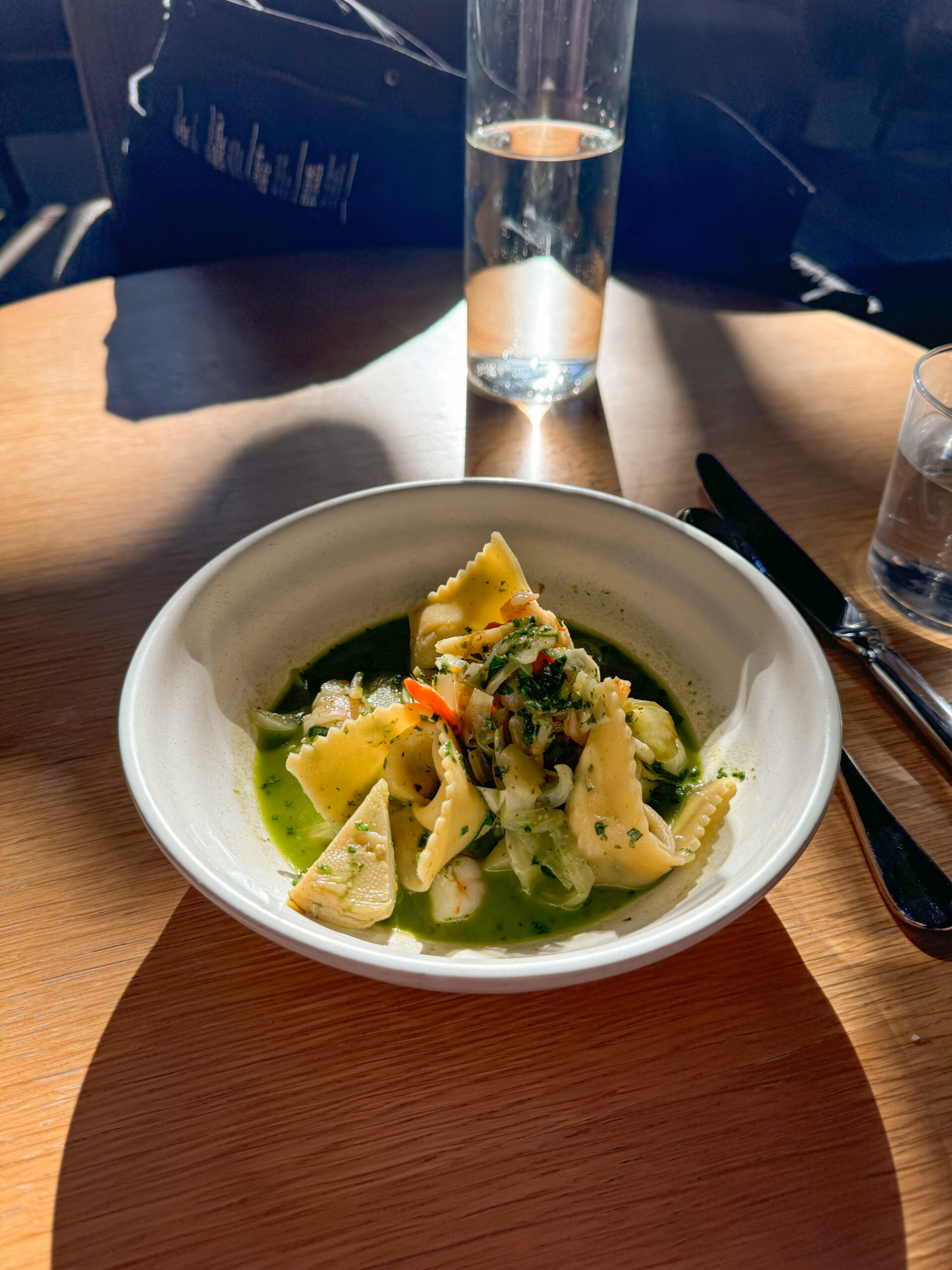 bowl of ravioli on wooden table.