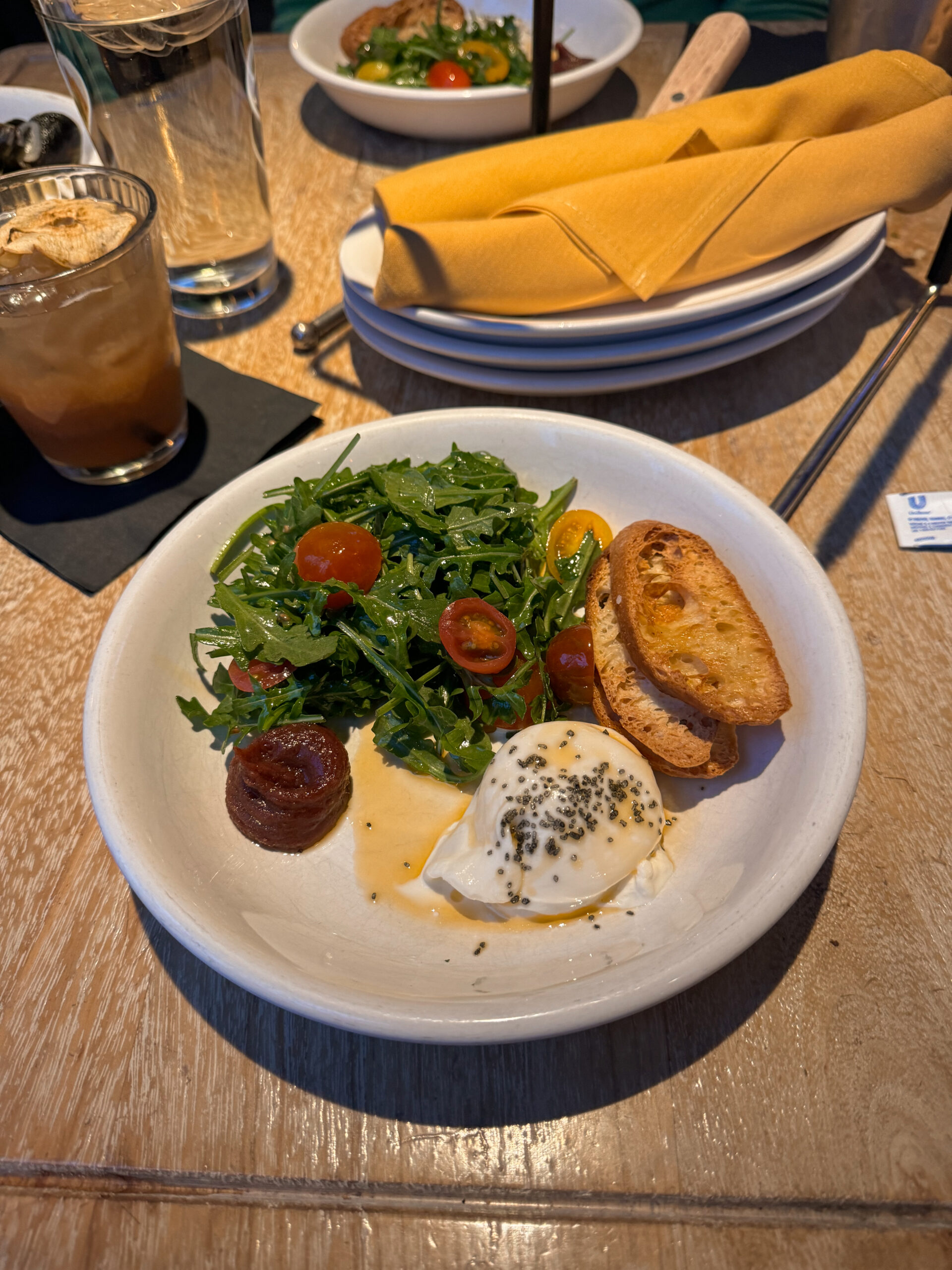 burrata appetizer on white plate.