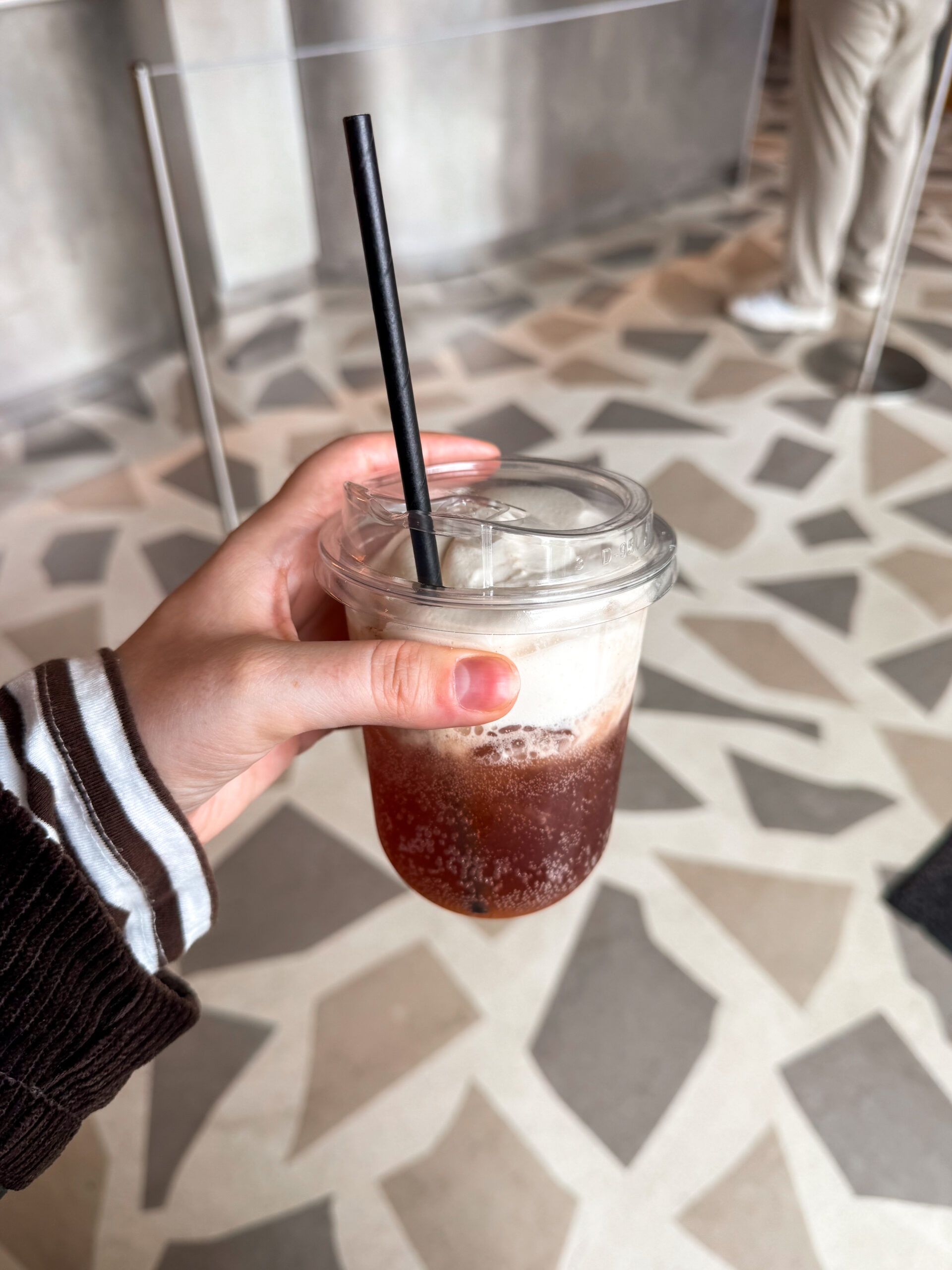 cherry cola soda in plastic cup.