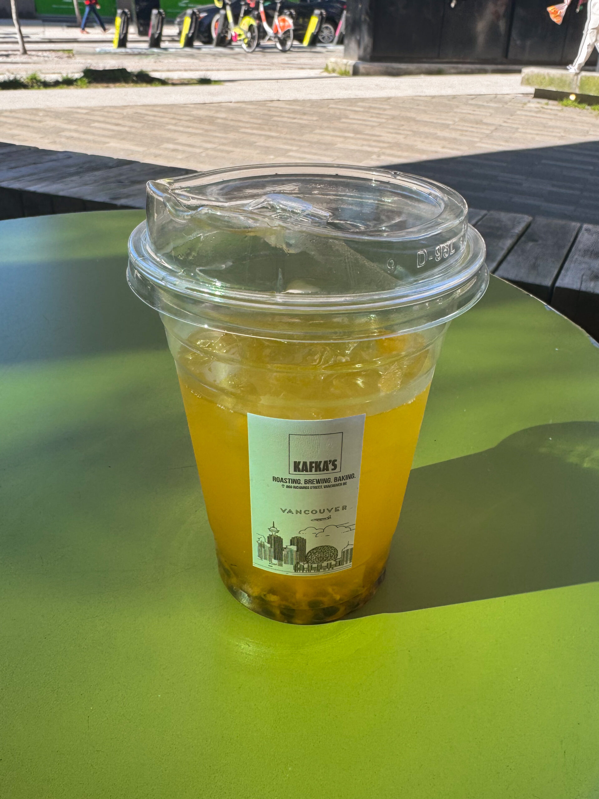 passionfruit drink on green patio table.