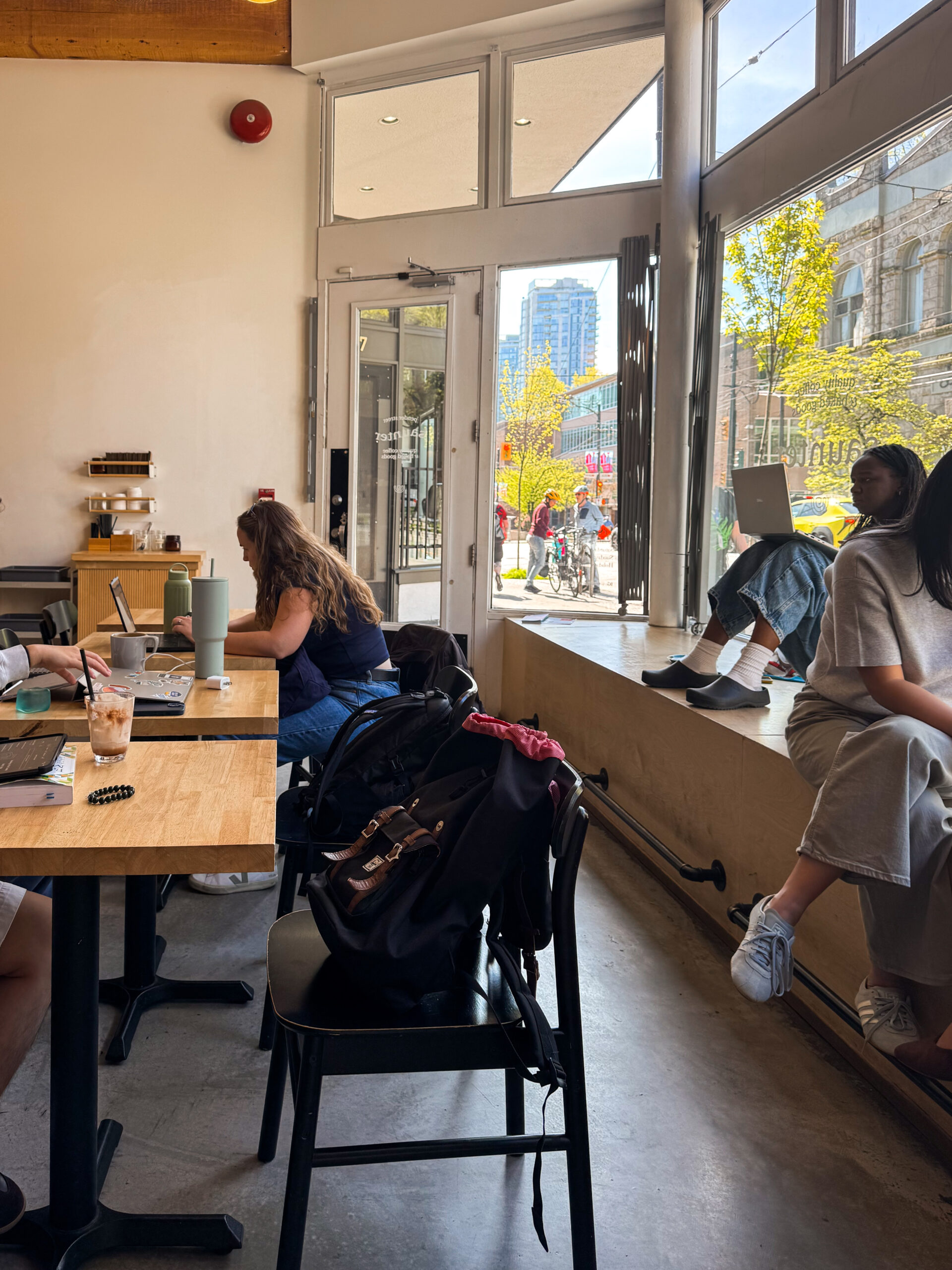 cafe work tables with patrons on laptops.