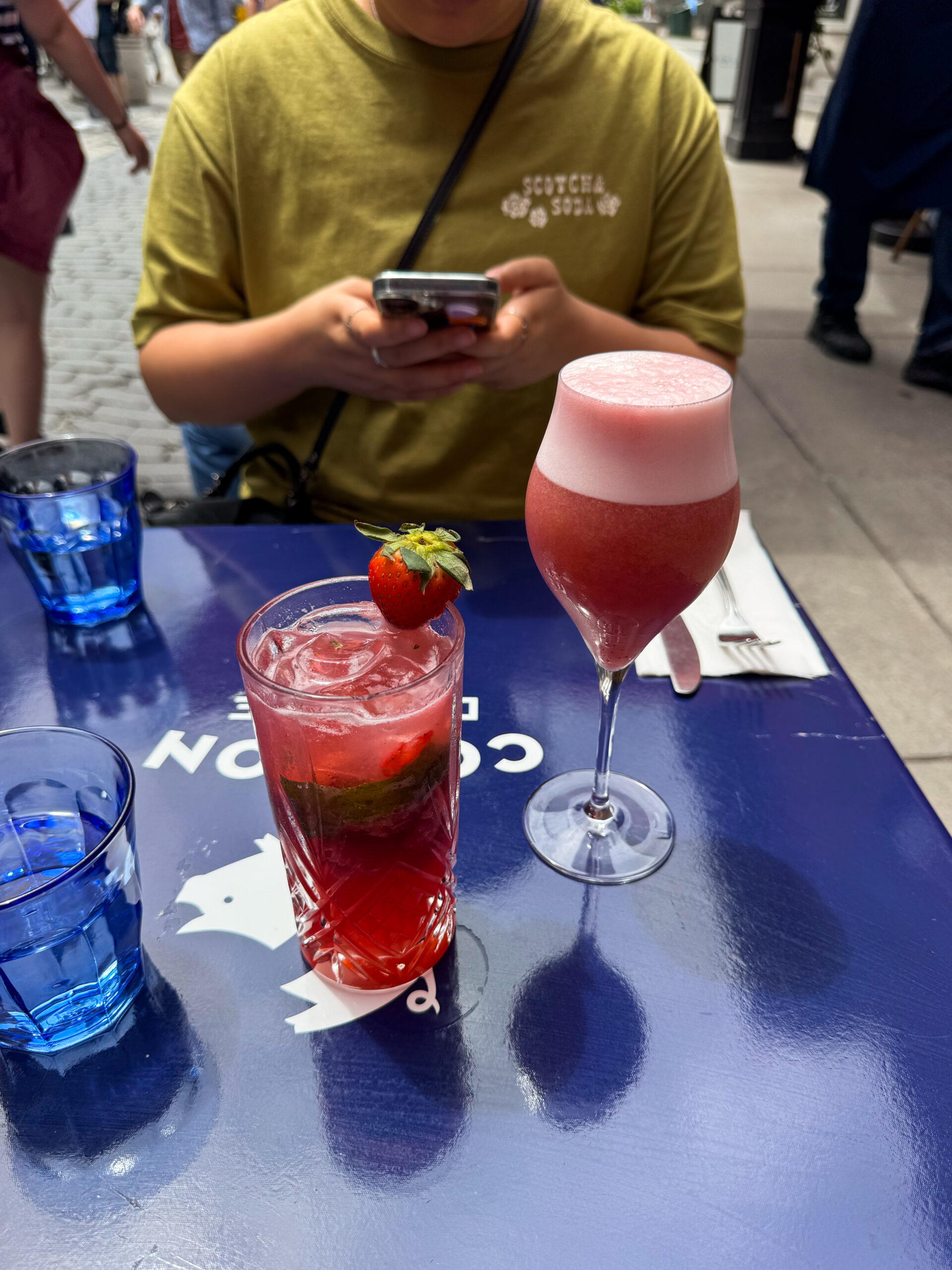 red and pink cocktails on table.
