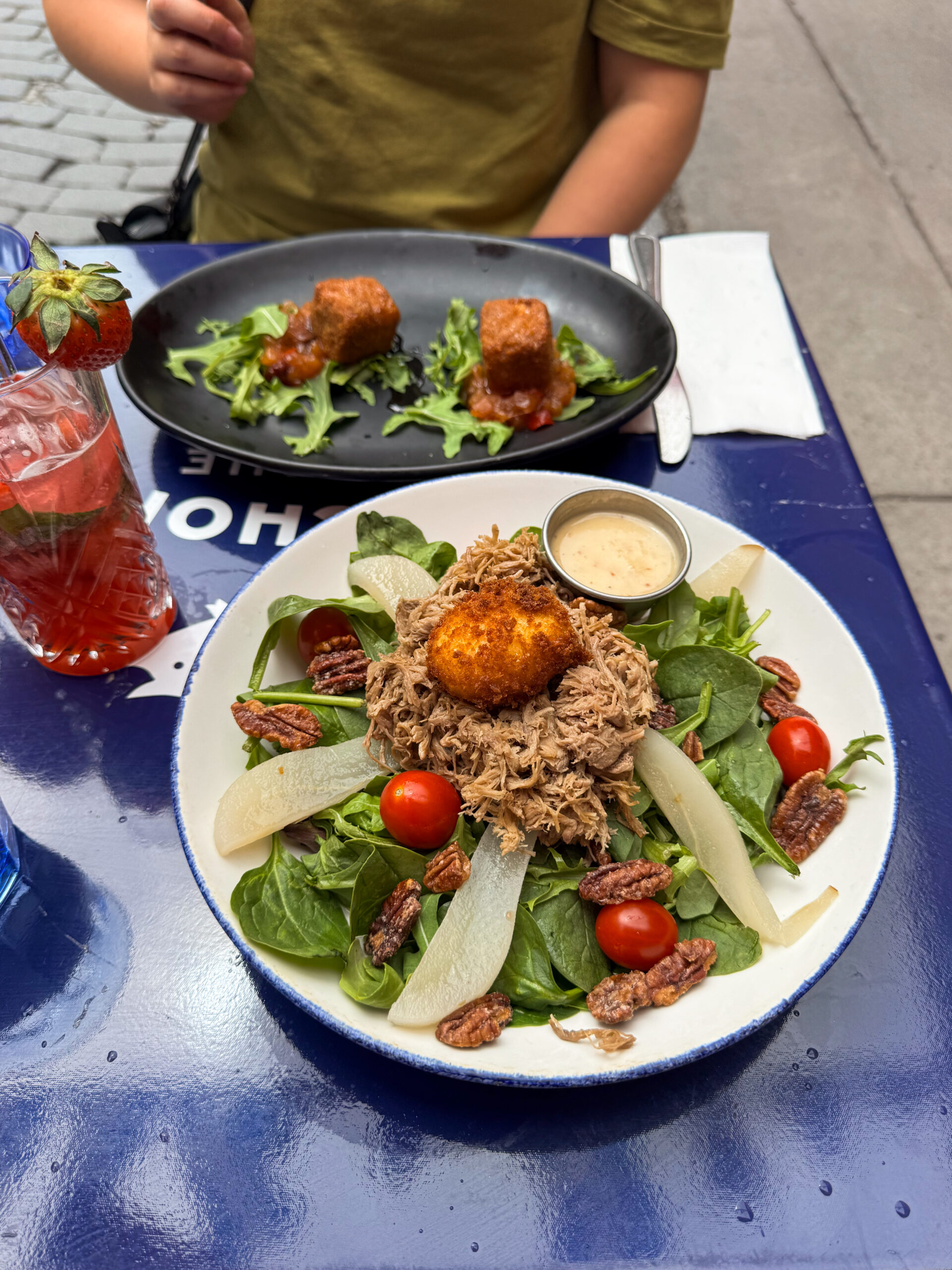 salad and croquettes on blue table.