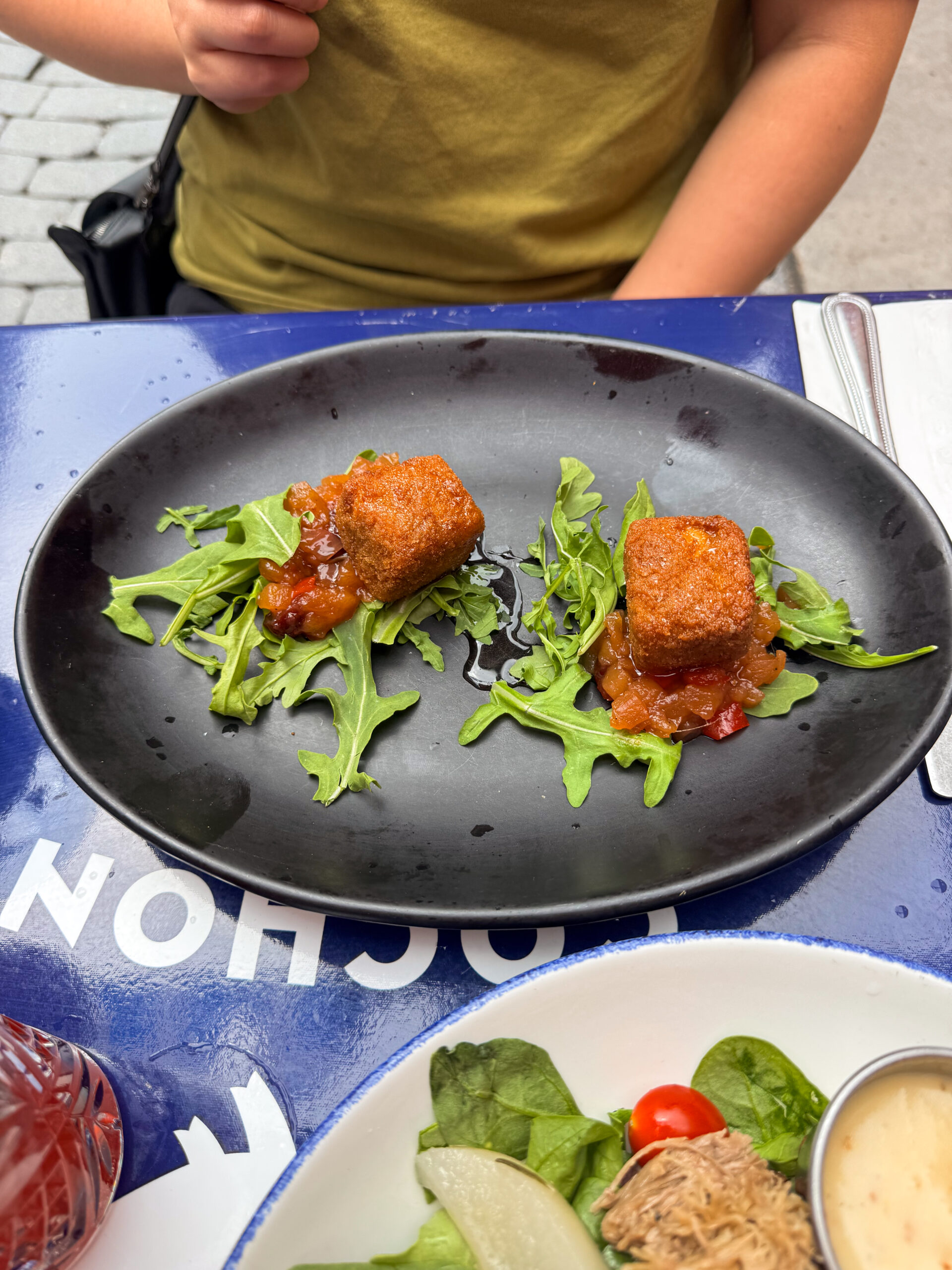 croquettes on black plate.
