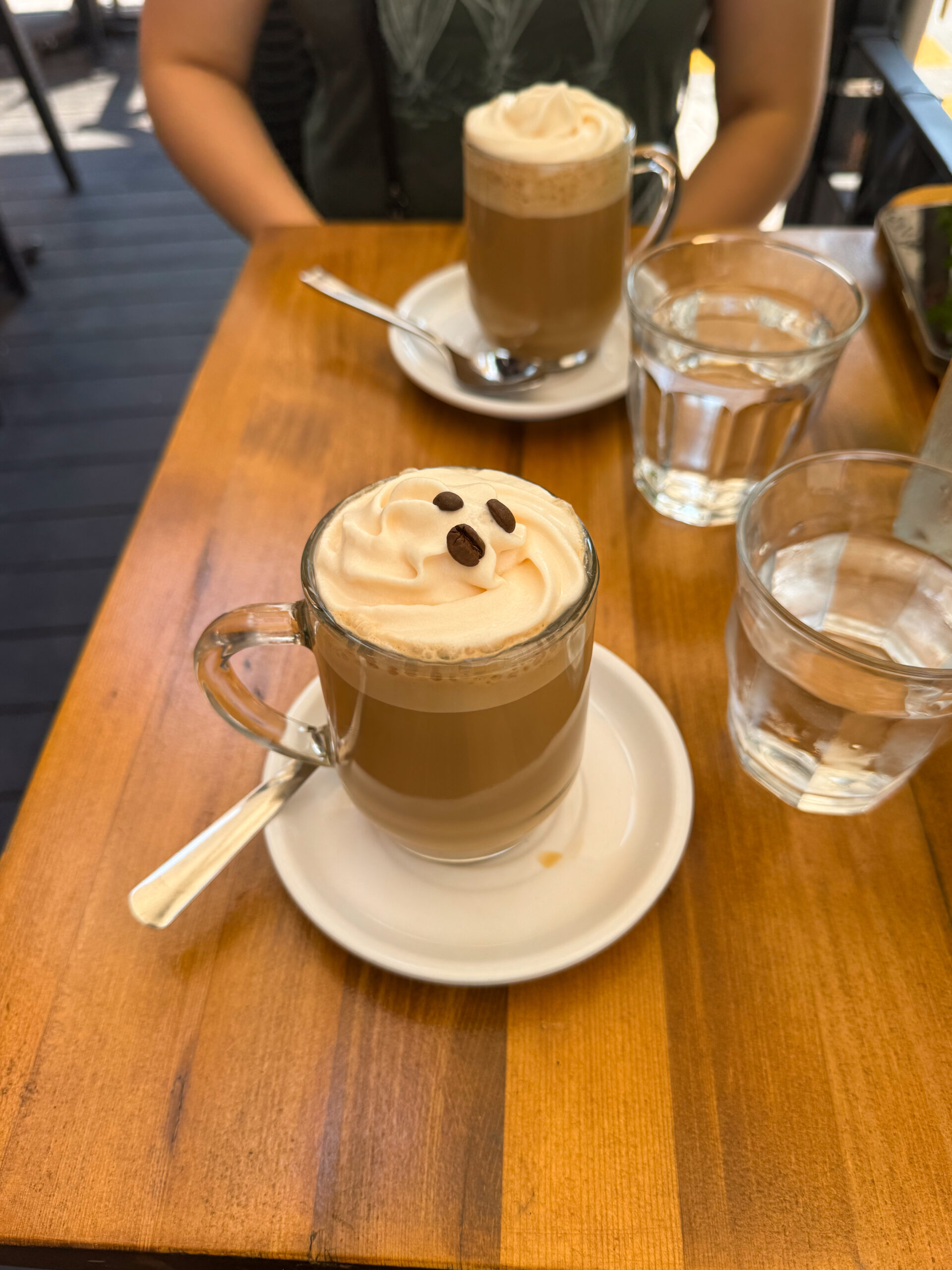 maple coffees on wooden table.