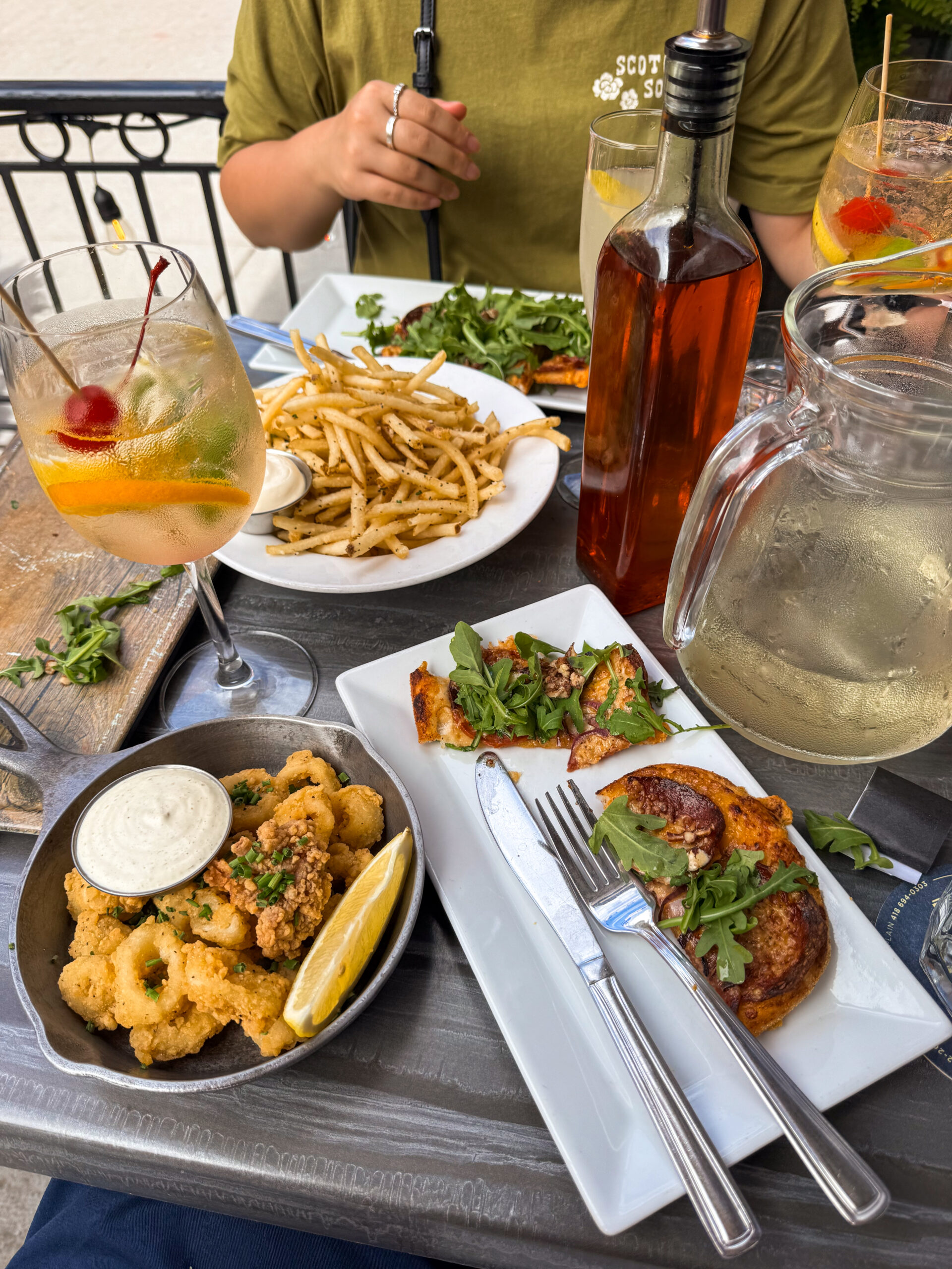 plates of food on restaurant patio table.