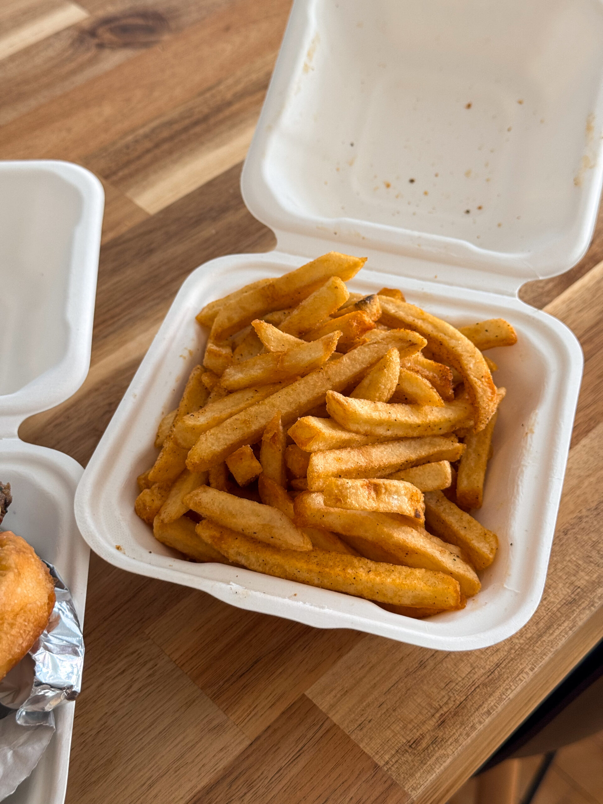 fries in takeout container.